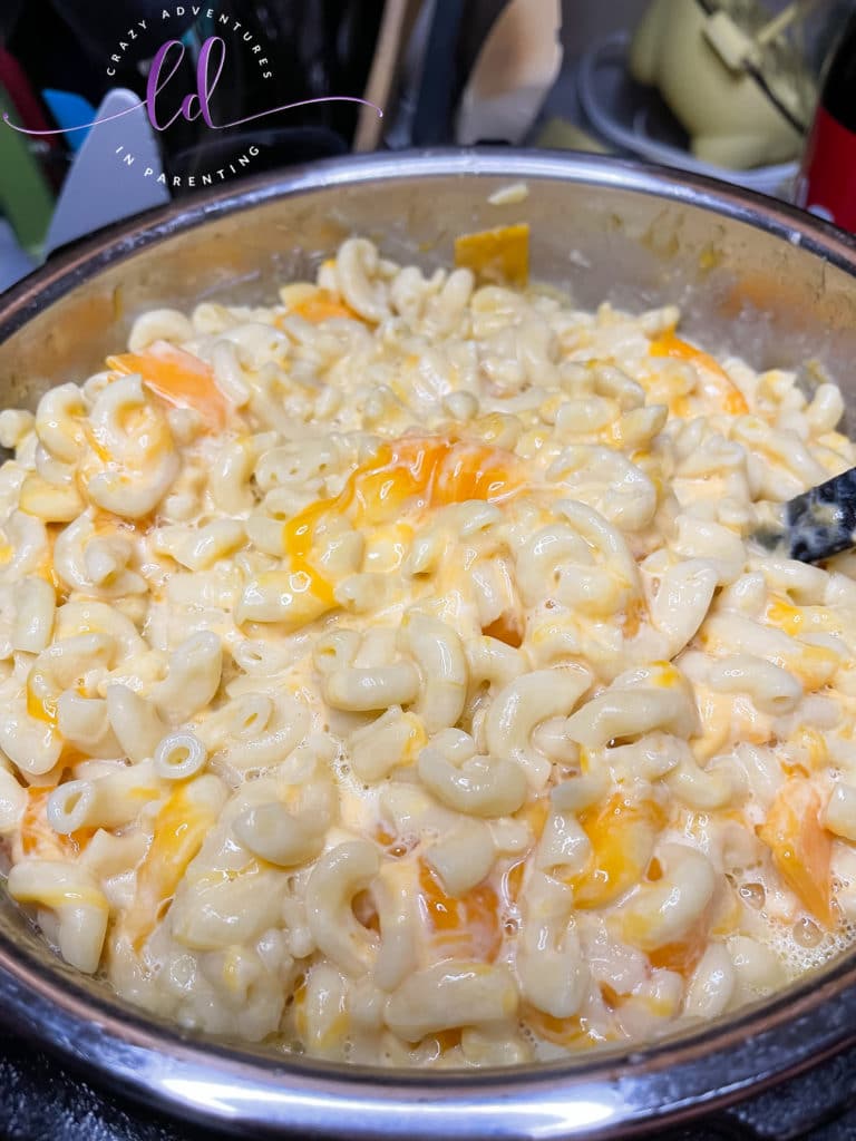 Stir milk and cheese mixture to make Instant Pot Queso Macaroni and Cheese
