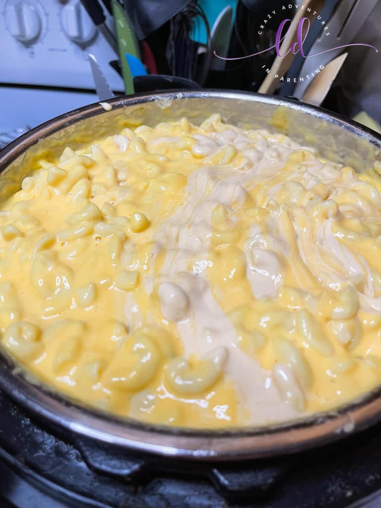 Stir queso completely to make Instant Pot Queso Macaroni and Cheese