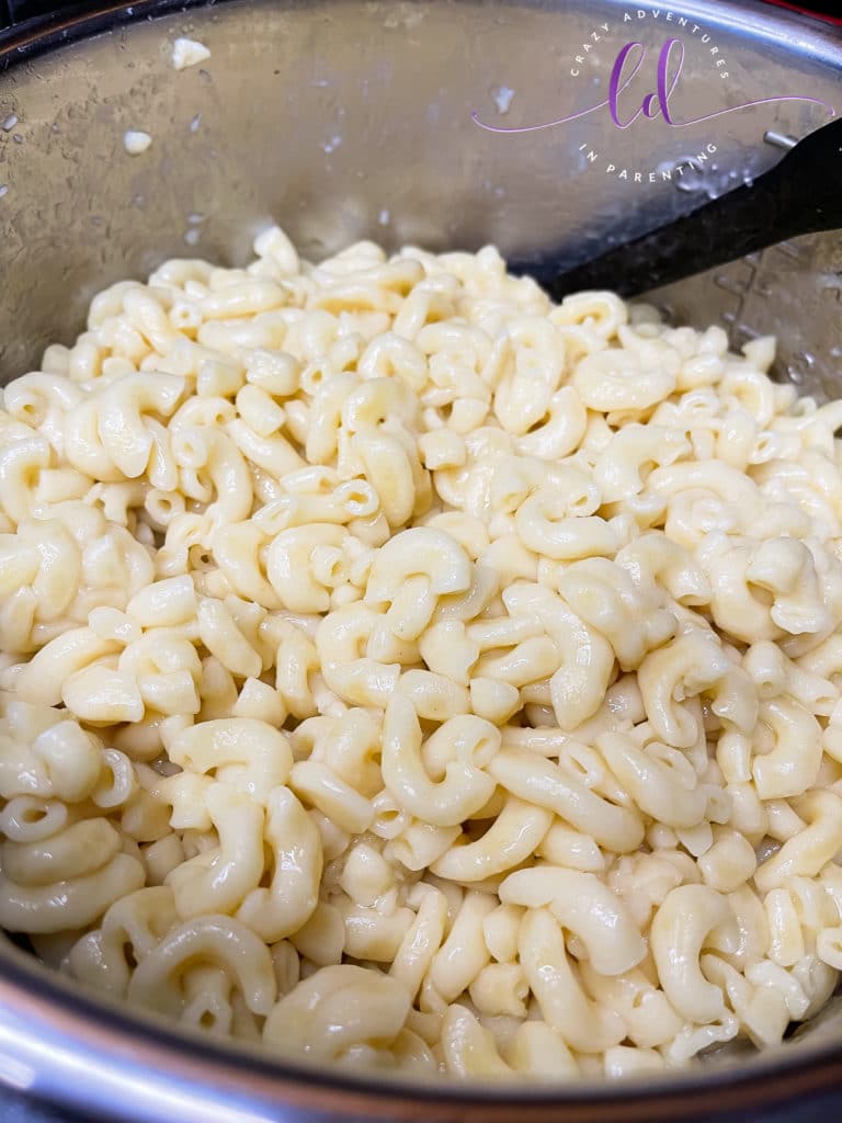Stir the cooked pasta and do not rinse to make Instant Pot Queso Macaroni and Cheese