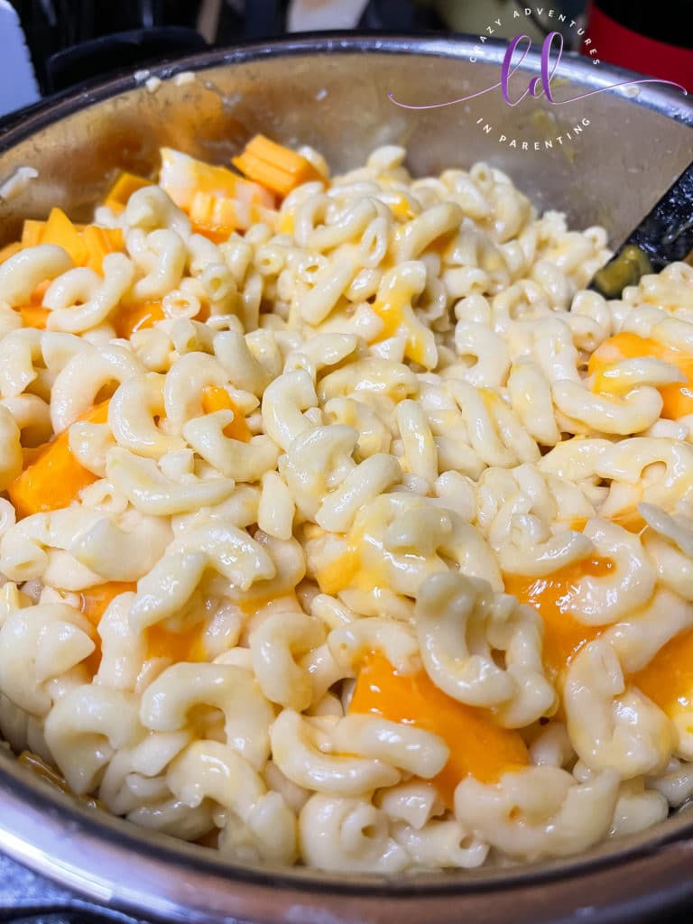 Stir to melt the cubed cheese to make Instant Pot Queso Macaroni and Cheese