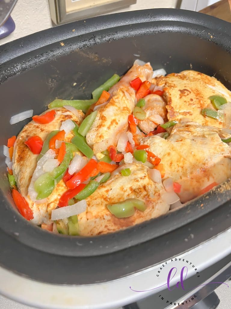 Flip chicken breasts as they cook in the pot to make Easy Creamy Chicken Tacos Recipe